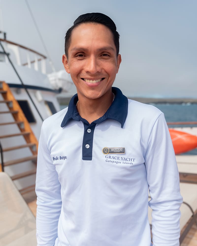 Smiling Quasar yacht crew member, a local of the Galapagos, on Grace yacht