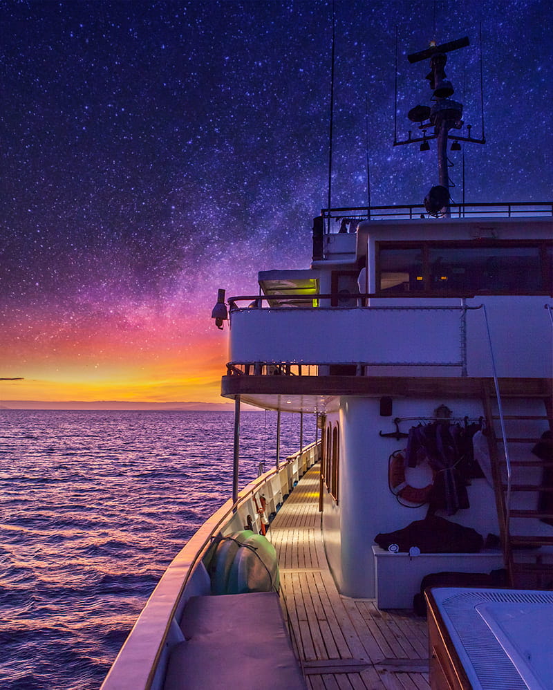 Starry night sky above the Grace Yacht in the Galapagos